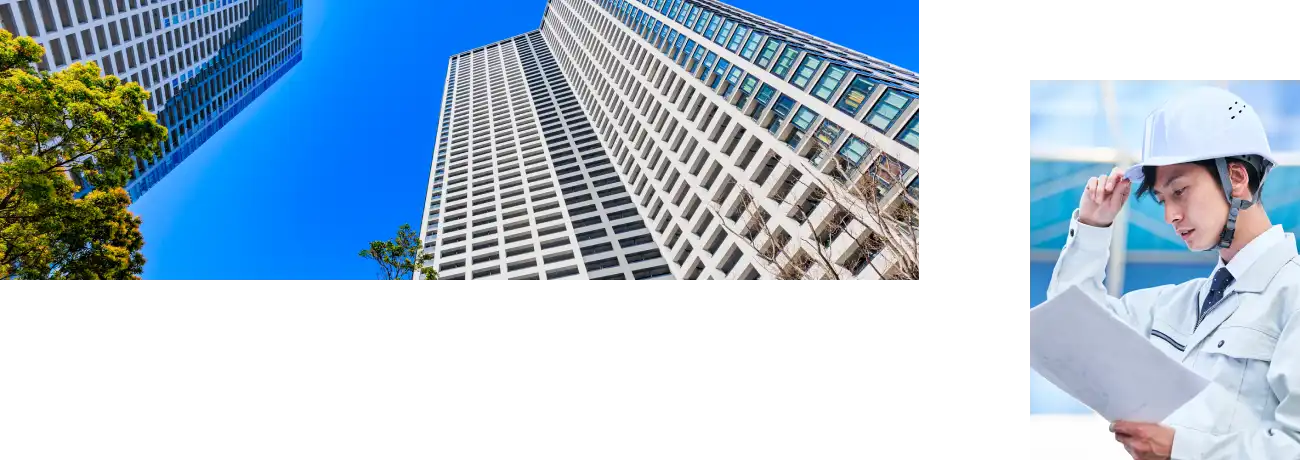 都会のビルと書類を見る男性の写真